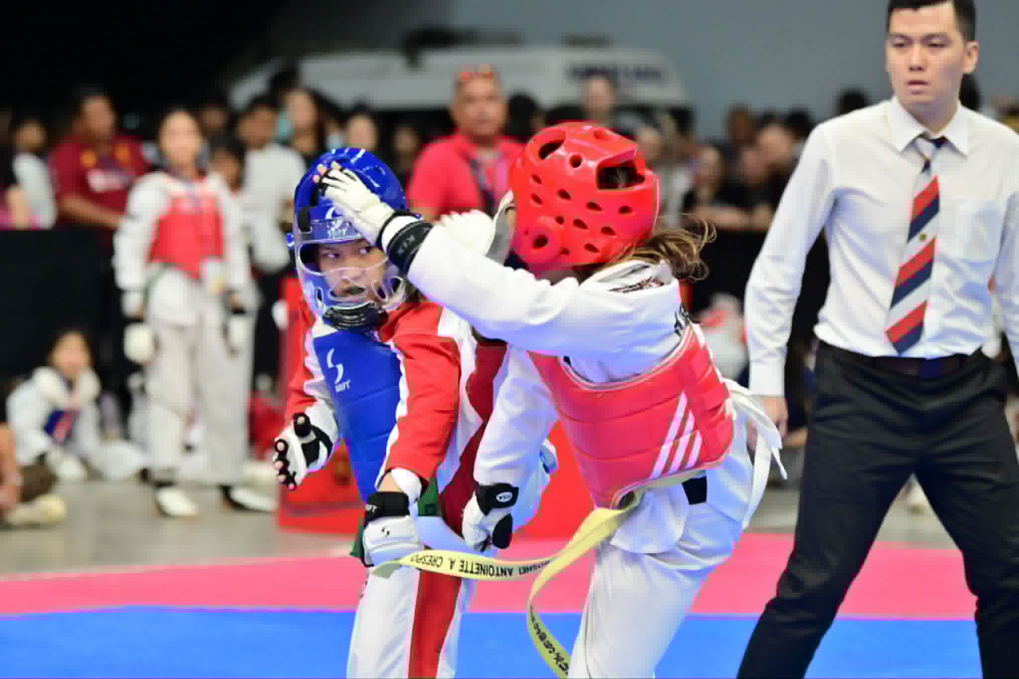 Taekwondo athletes competing during a match