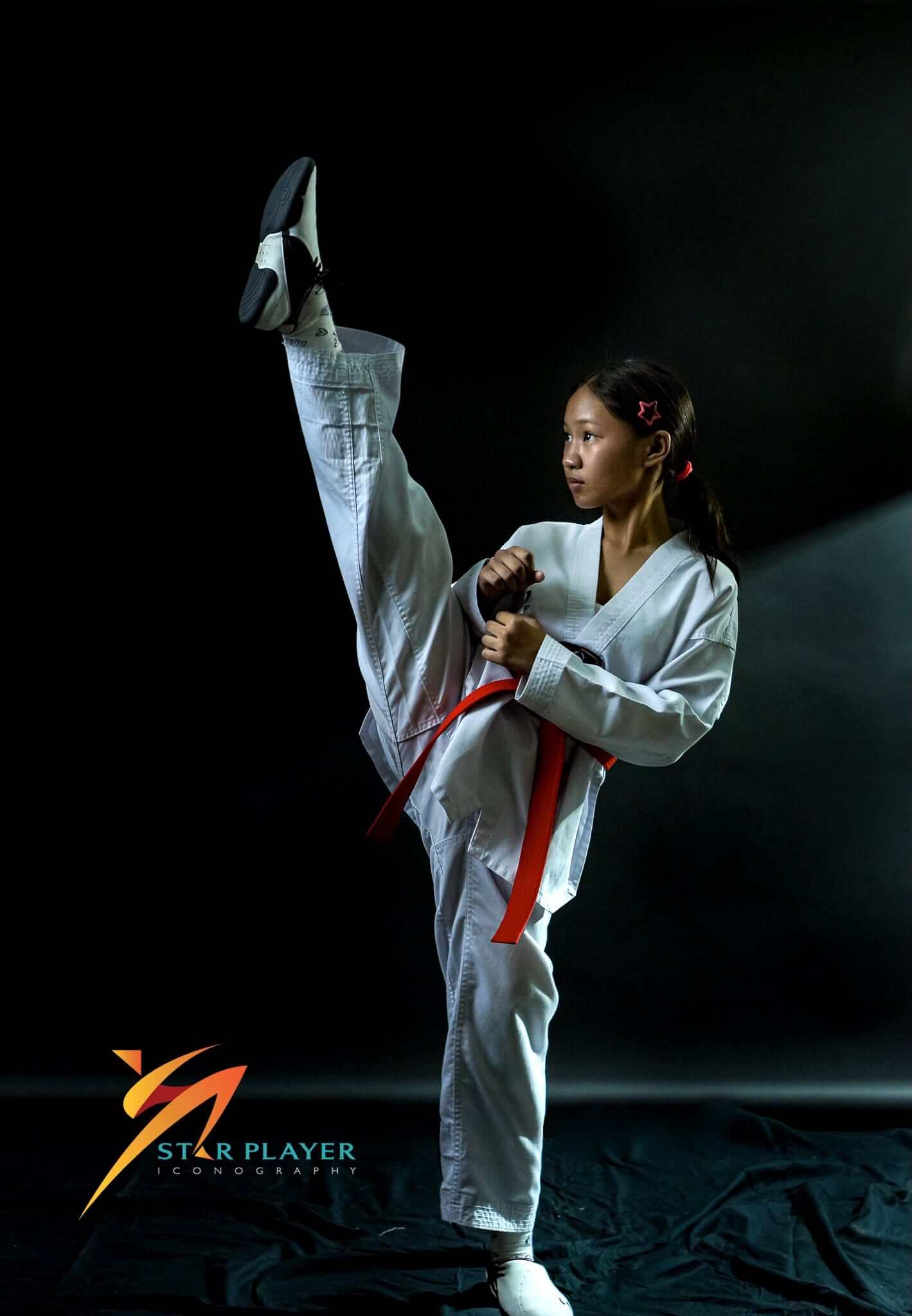Taekwondo athlete posing for a studio portrait